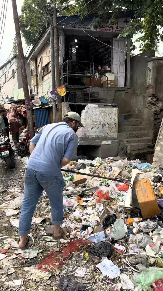 Burhan Dar transporting waste through town