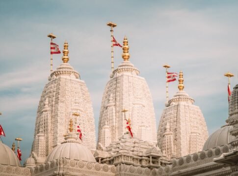 Beautiful white stone spires of BAPS Shri Swaminarayan temple against a clear sky. Beautiful white stone spires of BAPS Shri Swaminarayan temple against a clear sky.