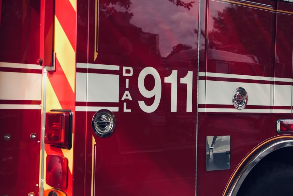 Fire Engulfs Coaching Centre in Lucknow; 14 Fire Tenders Battling Blaze Close-up shot of a firetruck's door featuring the 911 emergency number.