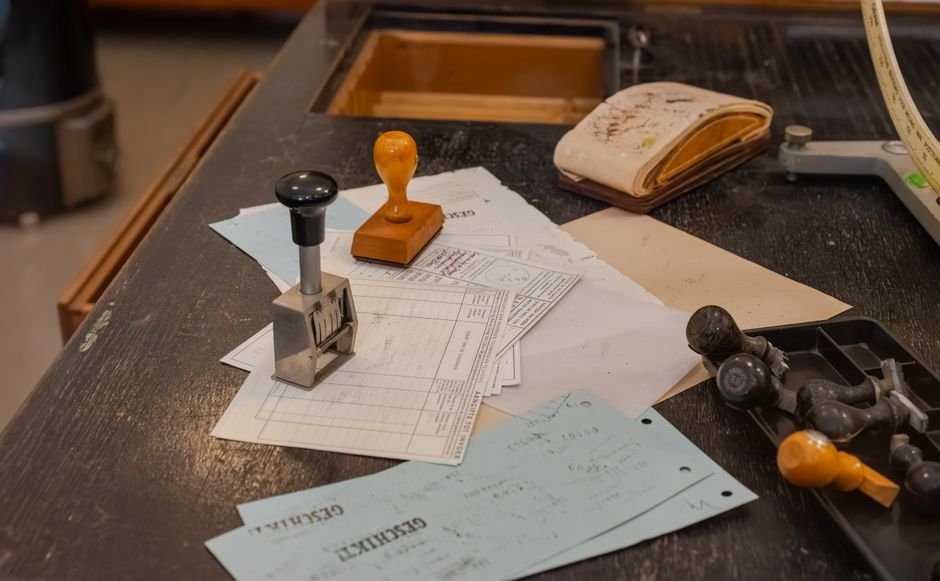 Punjab: Khanna SDM Halts Further Sale of Disputed Land Cluttered desk with office stamps on top of various documents in an office setting.