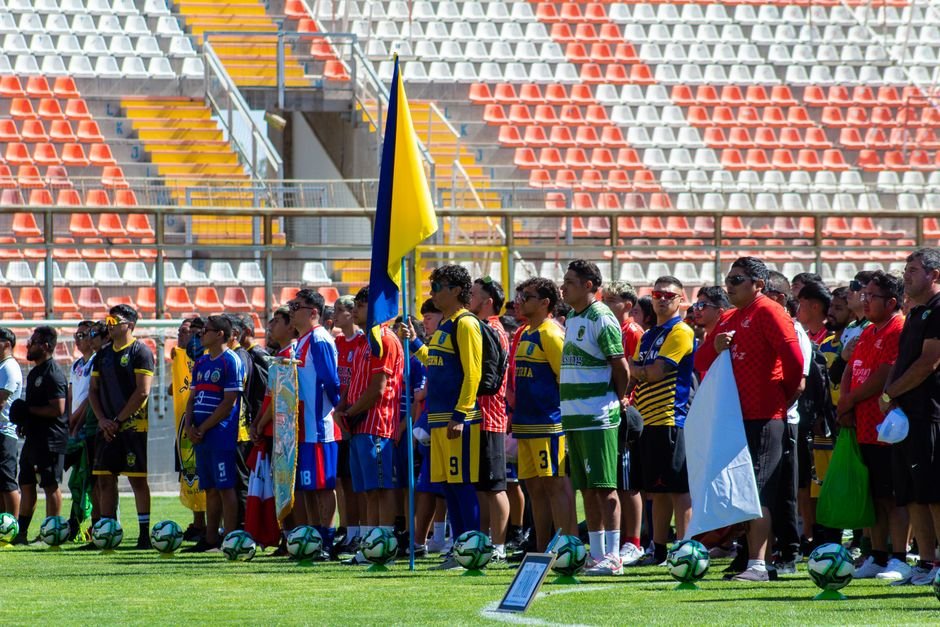 Curaçao Achieves Historic World Cup Qualification, Unites Caribbean Nation Colorful gathering of diverse soccer teams at a sunlit stadium.