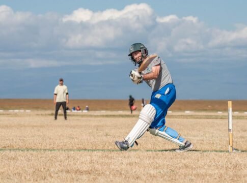 Cricketer hitting the ball during a match on a sunny day, showcasing athletic action and skill. Cricketer hitting the ball during a match on a sunny day, showcasing athletic action and skill.