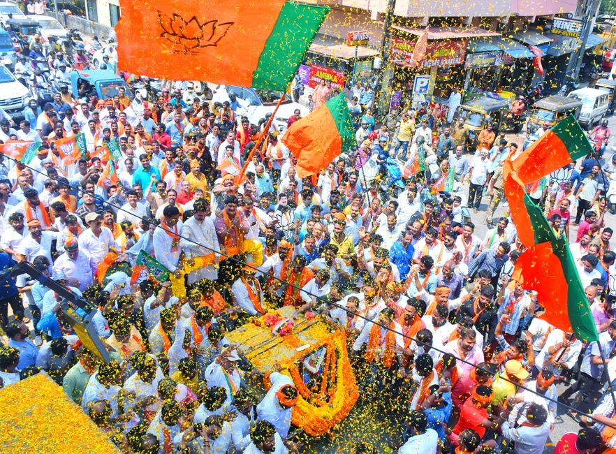 Andhra Pradesh: NDA Finalizes Mega Outreach in Tirupati, CM Naidu to Participate Crowds gather in Mangaluru for a colorful street parade with vibrant flags and decorations.