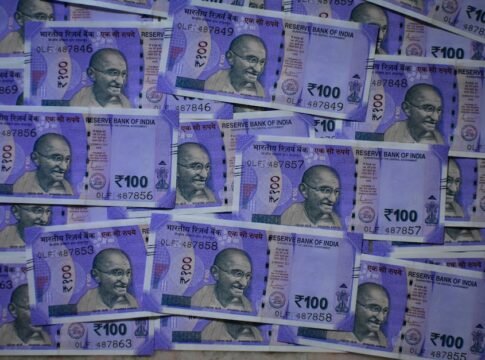 Detailed view of 100 Indian rupee notes featuring Mahatma Gandhi, symbolizing prosperity and economy.