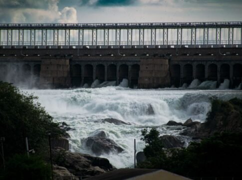 Dramatic view of a powerful waterfall cascading over a dam. Dramatic view of a powerful waterfall cascading over a dam.