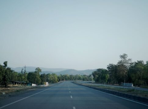 Empty highway through lush countryside of Ambikapur, CG, India under a clear sky. Empty highway through lush countryside of Ambikapur, CG, India under a clear sky.