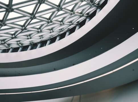 Explore this modern architecture featuring futuristic design and geometric patterns indoors.