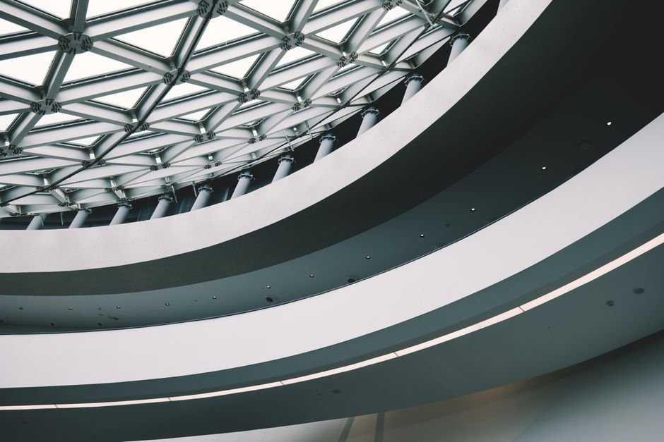 Explore this modern architecture featuring futuristic design and geometric patterns indoors.