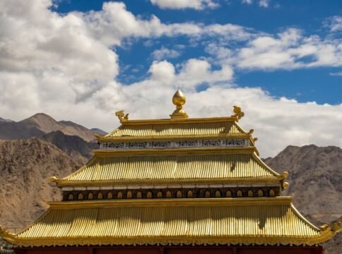 Golden temple roof with mountainous backdrop in Leh, India. Golden temple roof with mountainous backdrop in Leh, India.