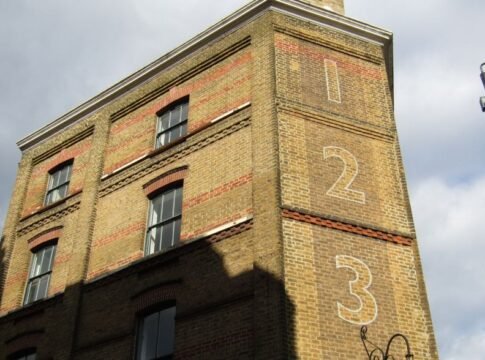 Historic London building with numbered facade and classic architecture in sunlight.
