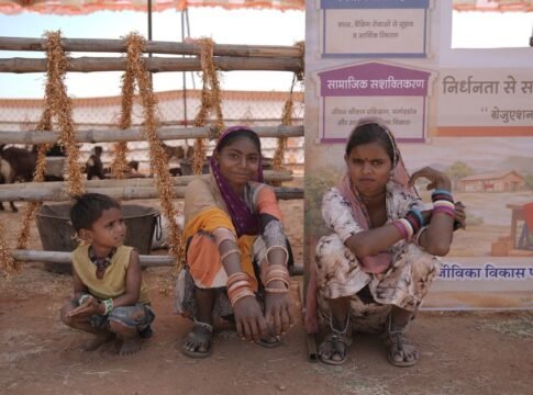 Indian village women and a child at a rural community event with cultural attire.