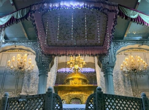Interior view of the stunning Golden Temple in Amritsar, showcasing intricate design and chandeliers.