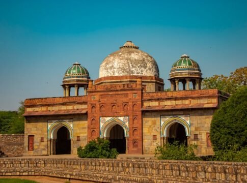 Isa Khan's Tomb with intricate architecture under a clear blue sky in Delhi, India. Isa Khan's Tomb with intricate architecture under a clear blue sky in Delhi, India.