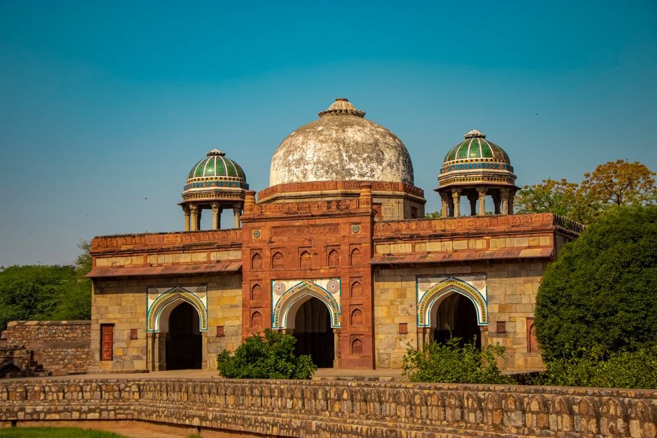 Pakistani National Repatriated to Pakistan-held Kashmir via Teetwal Friendship Bridge Isa Khan's Tomb with intricate architecture under a clear blue sky in Delhi, India.