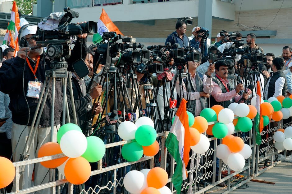 Journalists and videographers gather with cameras in Ahmedabad, capturing a vibrant scene.