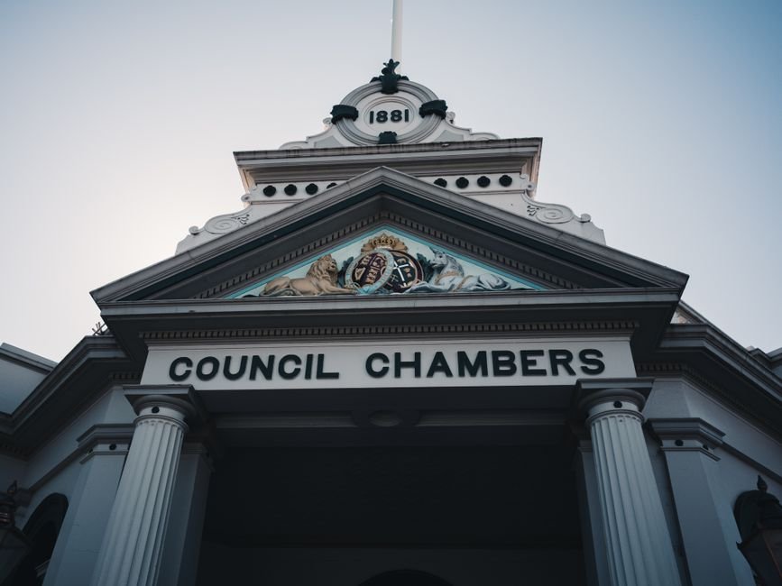 Ludhiana MC Commissioner Addresses Industrialists’ Civic Grievances Low angle view of a historic neoclassical council chambers facade with columns and ornate detailing.