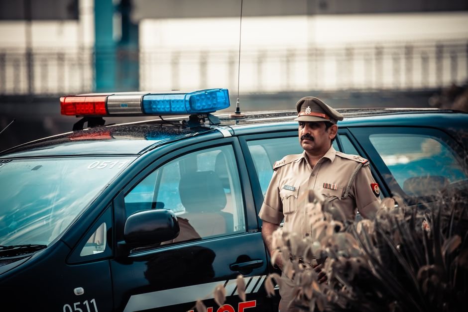 Jammu and Kashmir: Teenager Found Dead in Srinagar Home Male in uniform standing near patrol car with flashing lights and looking away