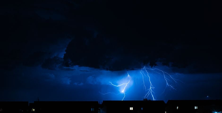 Jammu and Kashmir: Man Injured by Lightning Strike in North Kashmir’s Kupwara Powerful lightning illuminates the night sky during a storm, casting silhouettes over city rooftops.