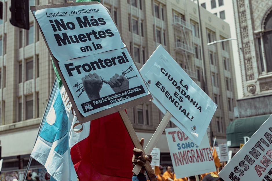 Canada Overhauls Citizenship Eligibility Rules, Expanding Access for Descendants Protesters in Los Angeles rally for immigration rights with powerful messages on signs.