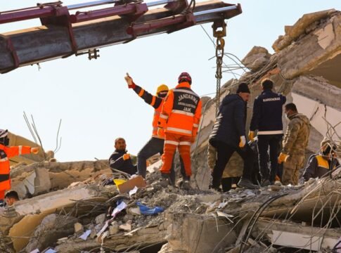 Rescue workers searching through rubble after an earthquake, showcasing teamwork and determination.