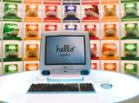 Retro Apple iMac G3 display showcasing technology evolution with colorful computer units.
