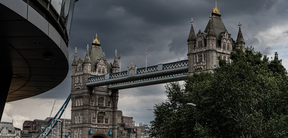 Six Nations Impose Sanctions Targeting Israeli Settler Networks Amid Violence Concerns Scenic view of Tower Bridge in London, showcasing its majestic architecture under a dramatic sky.