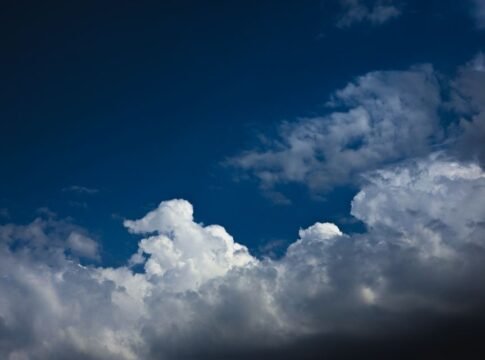 Stunning cumulonimbus clouds form a dramatic scene against a deep blue sky, capturing nature's beauty.