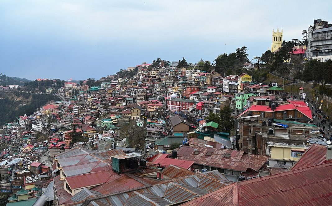Himachal Pradesh: Foreign Tourist Highlights Littering at Shimla’s Sacred Sites The image contains A view of the famous Christ Church in Shimla along with a cityscape of Shimla.on a cloudy day.