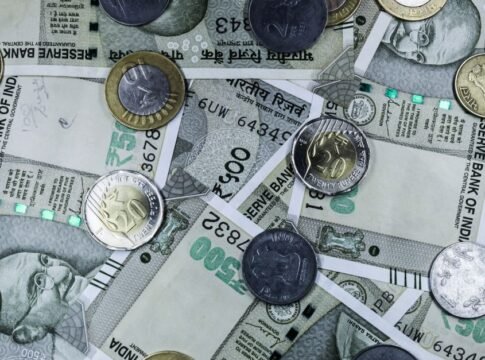 Top view of various Indian rupee banknotes and coins, highlighting financial themes. Top view of various Indian rupee banknotes and coins, highlighting financial themes.