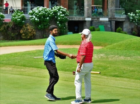 Two golfers shake hands on a lush green course in Hyderabad, India, celebrating their game. Two golfers shake hands on a lush green course in Hyderabad, India, celebrating their game.