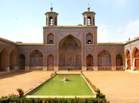 Vibrant courtyard of Nasir al-Mulk Mosque in Shiraz, showcasing stunning Persian architecture.