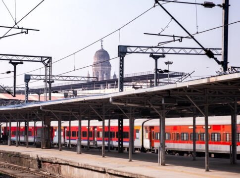 View of a train station in Mumbai with heritage architecture in the background, showcasing urban transport. View of a train station in Mumbai with heritage architecture in the background, showcasing urban transport.