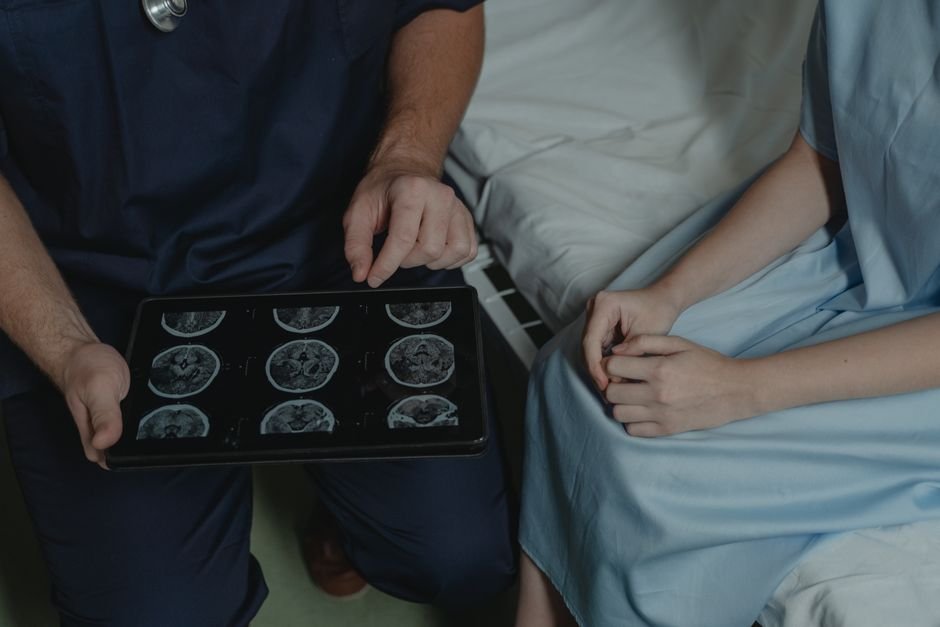 India: Neurologists Emphasize Quality Sleep for Brain Health Amidst Growing Screen Time A doctor shows and explains brain scan images to a patient in a medical setting.