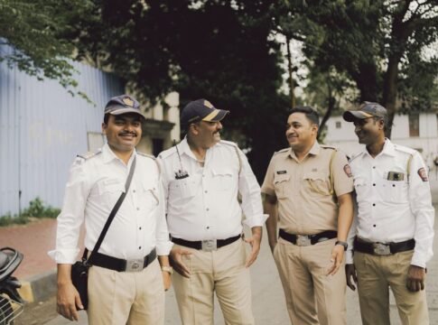 A group of friendly police officers smiling and standing on a street in Mumbai, India. A group of friendly police officers smiling and standing on a street in Mumbai, India.