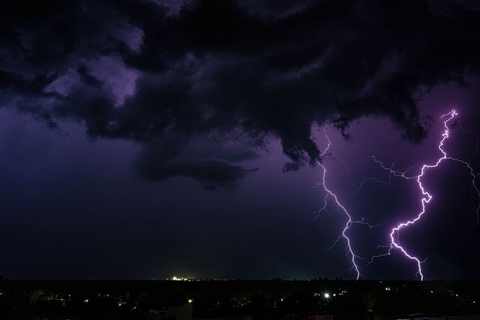 Jammu and Kashmir Braces for Intensified Rainfall; IMD Warns of Flash Floods, Landslides A powerful thunderstorm with dramatic lightning strikes over a city at night in India.