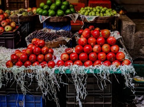 A vibrant display of assorted fruits in a lively market setting.