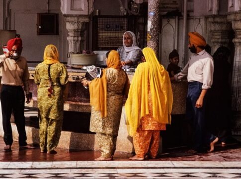A vibrant scene capturing people at a Sikh temple in India, showcasing cultural tradition.