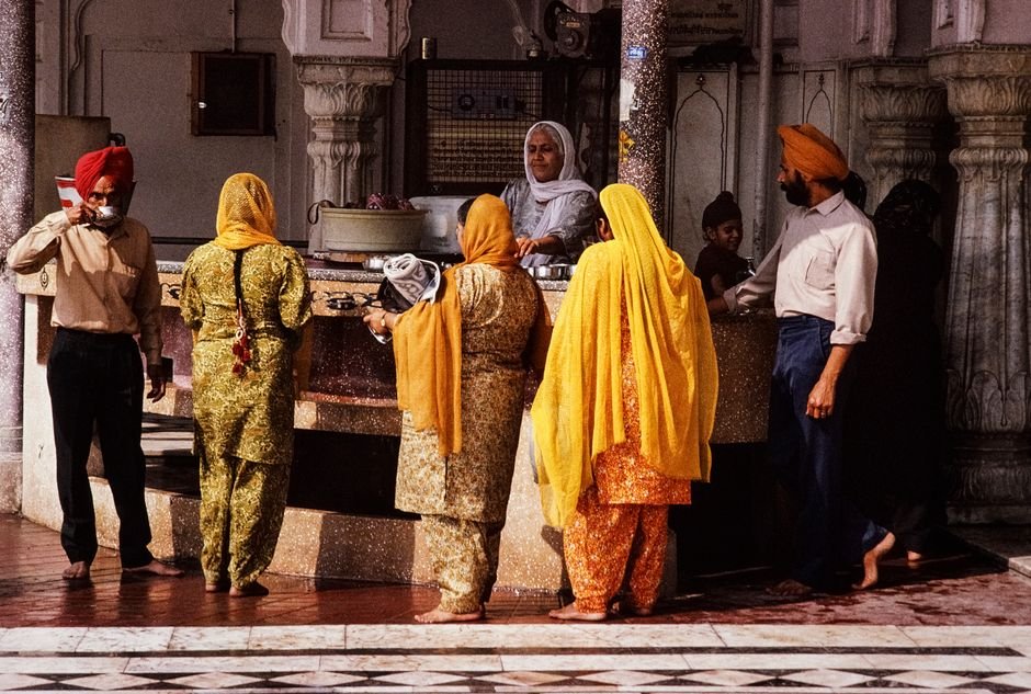 Punjab: SGPC Ramps Up Preparations for Panthic Gathering Amid Bhagwant Mann Video Controversy A vibrant scene capturing people at a Sikh temple in India, showcasing cultural tradition.