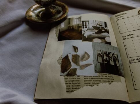 A vintage scrapbook featuring artistic photographs and journal entries, evoking nostalgia.