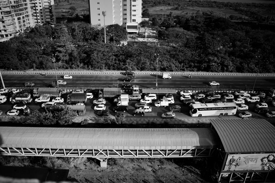 Black and white aerial view of a busy traffic jam on a Mumbai expressway.