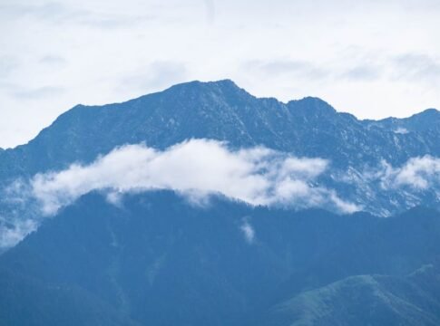Captured mountain peaks with floating clouds and fog on a serene day. Captured mountain peaks with floating clouds and fog on a serene day.