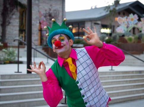 Cheerful clown in vibrant costume performing playfully in İstanbul street setting. Cheerful clown in vibrant costume performing playfully in İstanbul street setting.