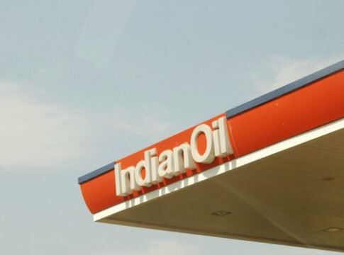 Close-up view of Indian Oil Corporation's petrol station canopy against clear sky. Close-up view of Indian Oil Corporation's petrol station canopy against clear sky.