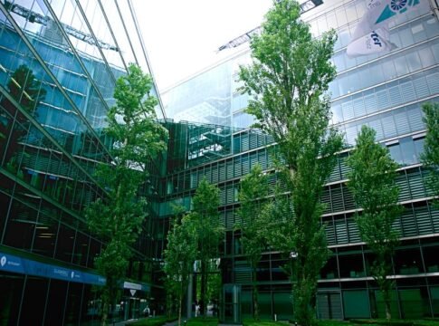 Contemporary glass architecture with trees reflecting in the facade on a bright day. Contemporary glass architecture with trees reflecting in the facade on a bright day.