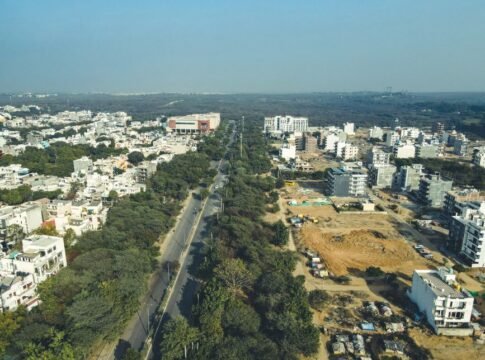 Drone shot capturing the expansive urban landscape and development in Gurugram, India.