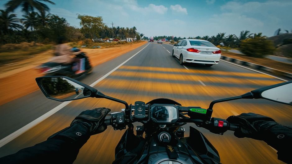 Pune-Bengaluru Highway Section Collapses Near Belagavi Amidst Heavy Rainfall Dynamic POV view of a biker riding on a bustling Indian highway in Bengaluru.