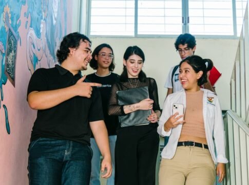 Group of diverse university students engaged in conversation on campus stairs in Culiacán. Group of diverse university students engaged in conversation on campus stairs in Culiacán.