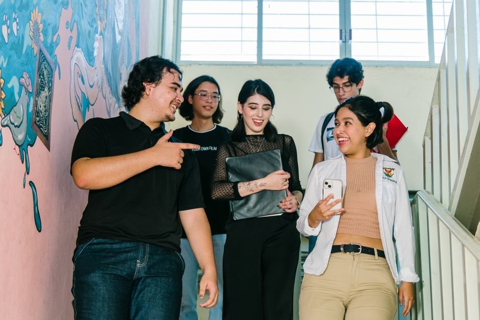 Himachal Pradesh ITI Students Gain Global Work Culture Insights During Kazakhstan Visit Group of diverse university students engaged in conversation on campus stairs in Culiacán.