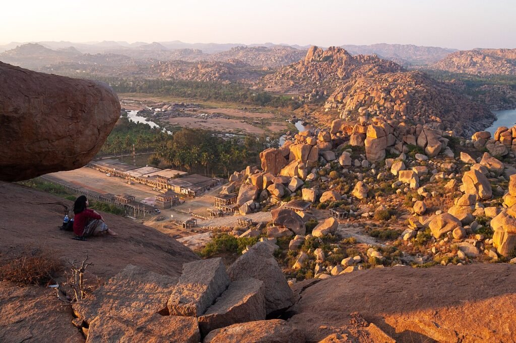 Hampi's ancient granite boulder landscape from Matanga Hill at sunset. Matanga Hill is one of the holy places described in the Ramayana epic. The boulders where the Tungabhadra River makes its bends …