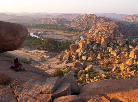 Hampi's ancient granite boulder landscape from Matanga Hill at sunset. Matanga Hill is one of the holy places described in the Ramayana epic. The boulders where the Tungabhadra River makes its bends …